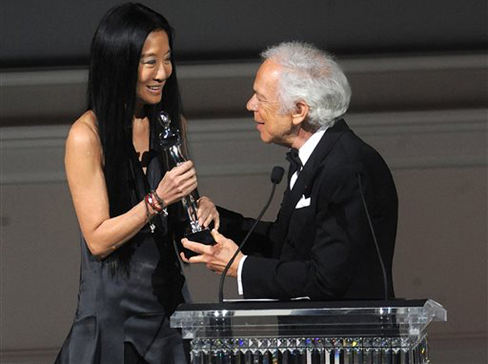 Designer Vera Wang is presented with an award by fellow designer Ralph Lauren at the 2013 CFDA Fashion Awards.